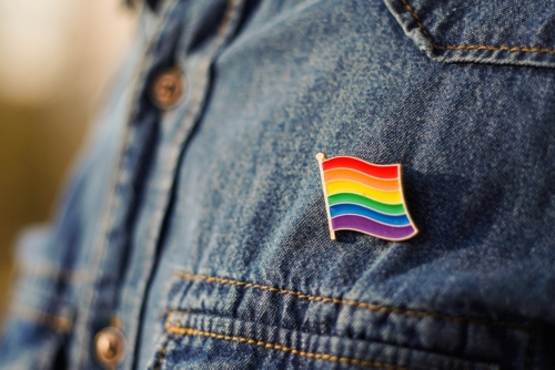 Close on a pride pin for LGBTQ+ employees
