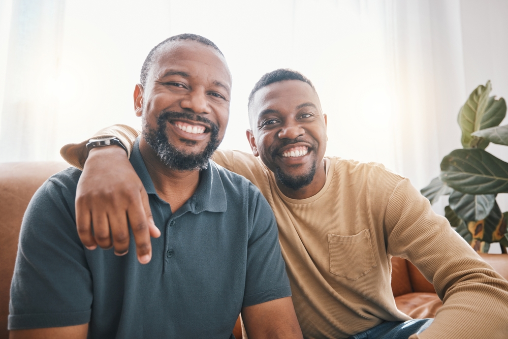 Senior,African,Dad,,Son,And,Sofa,For,Portrait,,Hug,And